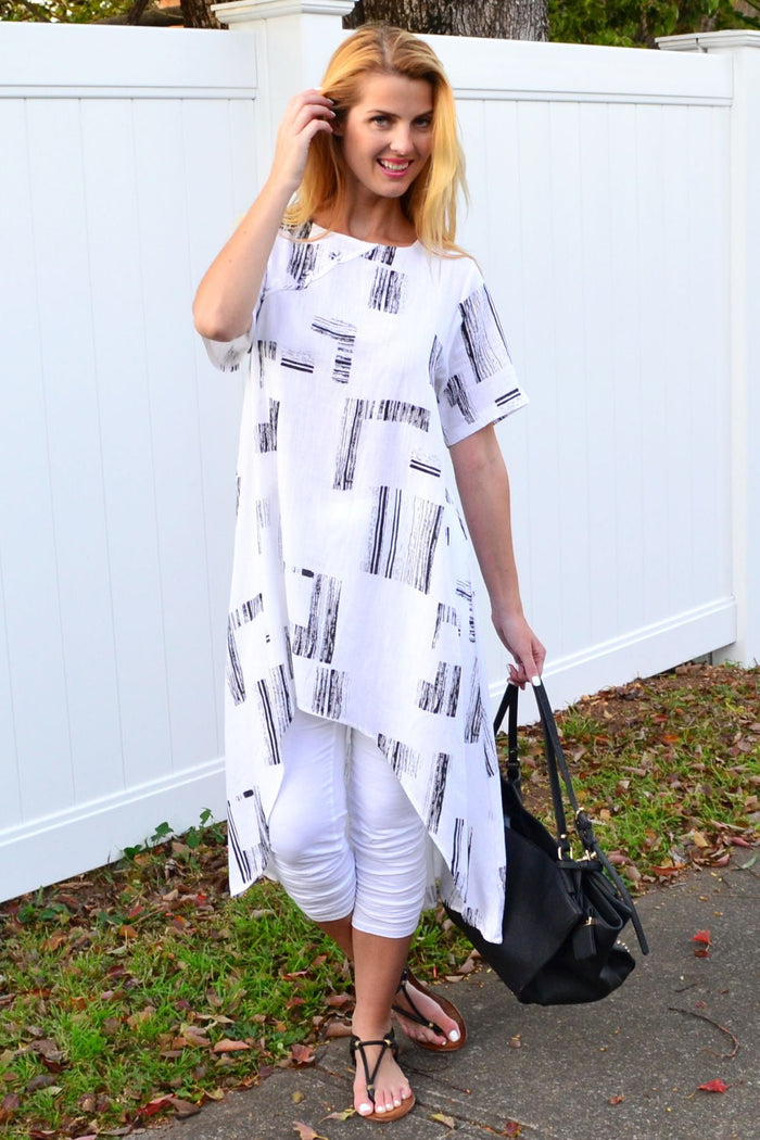 White pattern linen tunic with hi-low hem, asymmetrical design by Ruby Rain, shown as a long, stylish women's tunic dress.