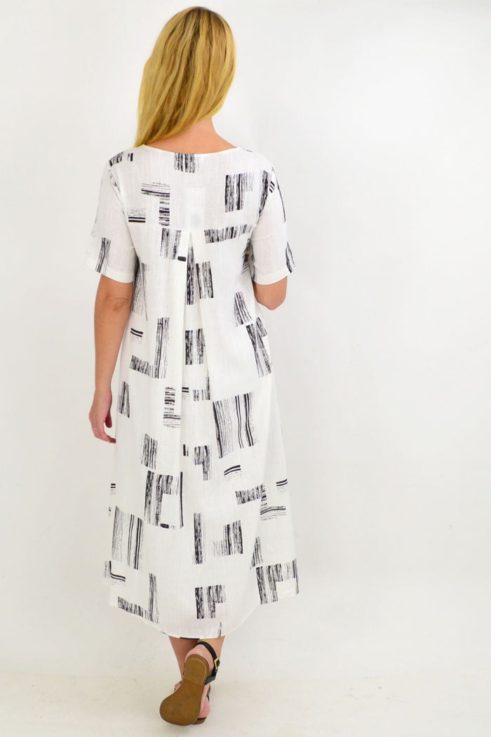 White pattern linen tunic with hi-low hem from Ruby Rain, featuring an asymmetrical design and casual, flowy fit.