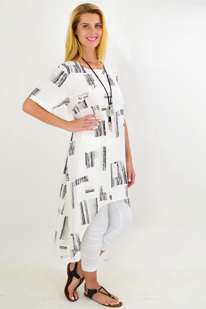 White pattern linen tunic with a hi-low hem from Ruby Rain, featuring an asymmetrical design and long, flowing silhouette.