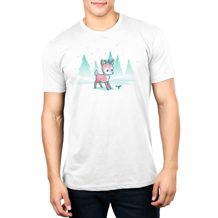 Premium Cotton T-shirt_TeeTurtle white Winter Wonderland apparel featuring a cartoon deer with small antlers stands in a snowy landscape with evergreen trees, looking curiously at a glowing sprout on the ground. Snowflakes are falling around them.